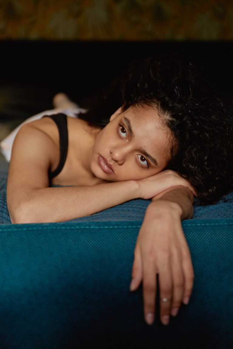 woman lying on bed looking up