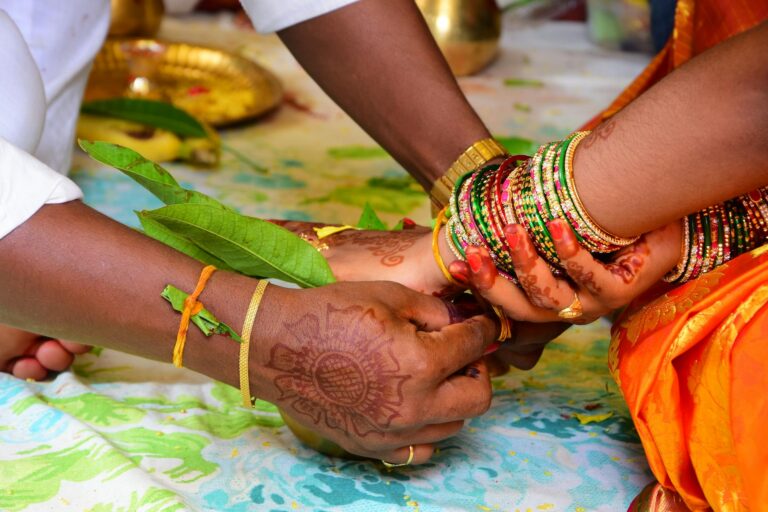 woman touching hand with bracelets