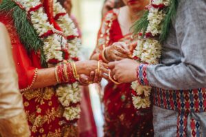 close up on hands of man and woman during a traditional wedding ceremony